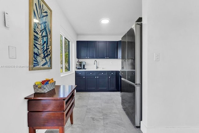 kitchen with stainless steel fridge and sink