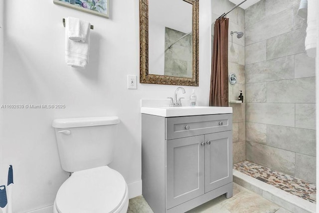 bathroom featuring toilet, walk in shower, and vanity