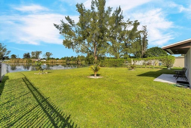 view of yard featuring a water view and a patio