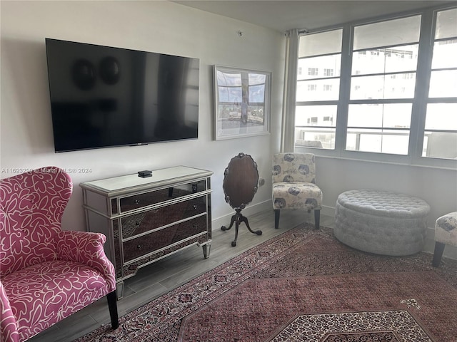 living area with a wealth of natural light and wood-type flooring