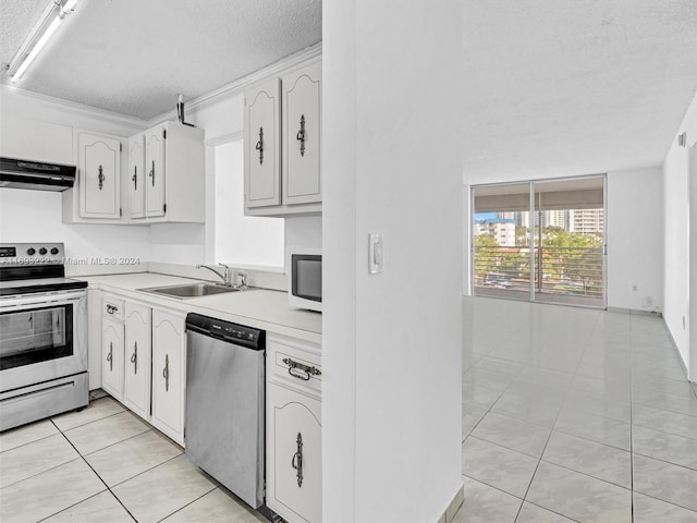 kitchen with ventilation hood, white cabinetry, sink, and appliances with stainless steel finishes