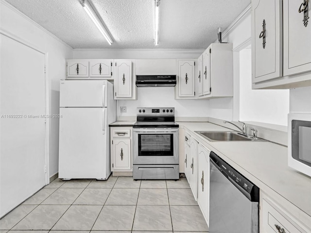 kitchen featuring white cabinetry, appliances with stainless steel finishes, a textured ceiling, light tile patterned floors, and sink