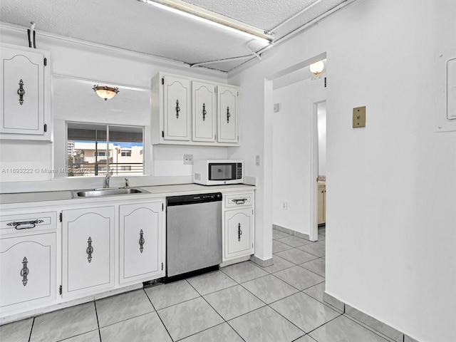 kitchen with dishwasher, white cabinetry, sink, and light tile patterned floors