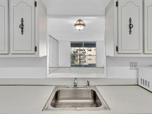 kitchen featuring white cabinets and sink