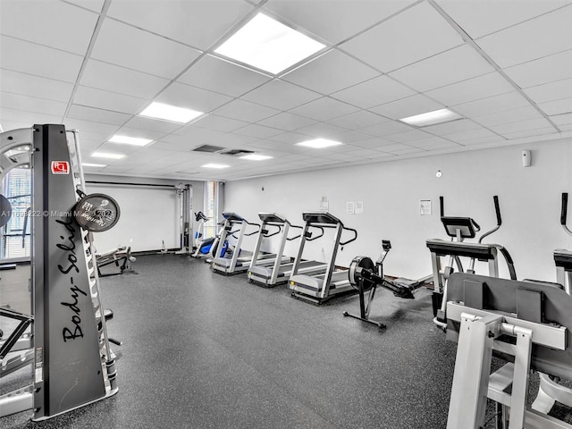 exercise room with a paneled ceiling