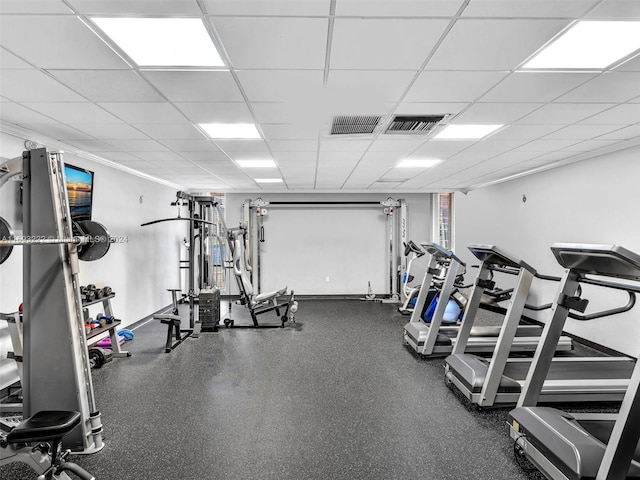 exercise room featuring a paneled ceiling