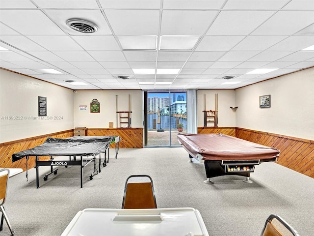 rec room with a drop ceiling, pool table, and wooden walls