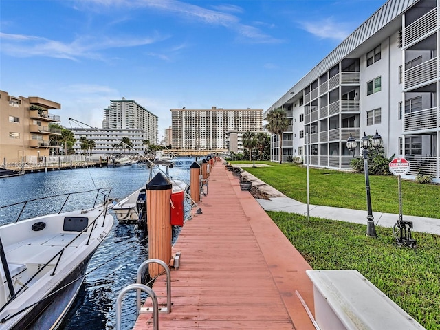 dock area featuring a lawn and a water view