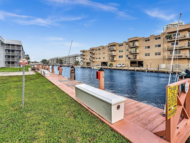 dock area featuring a water view and a yard