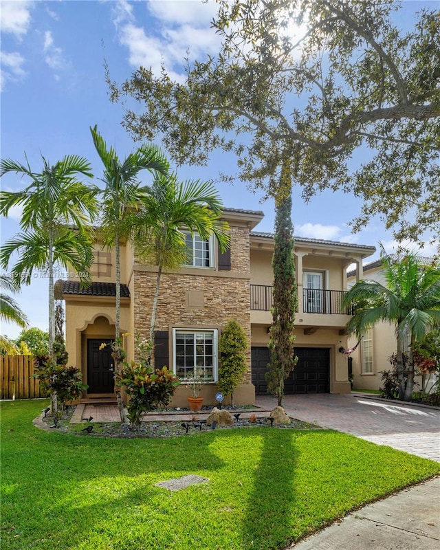 view of front of home featuring a balcony, a garage, and a front lawn