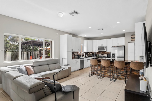 living room with sink and light tile patterned floors