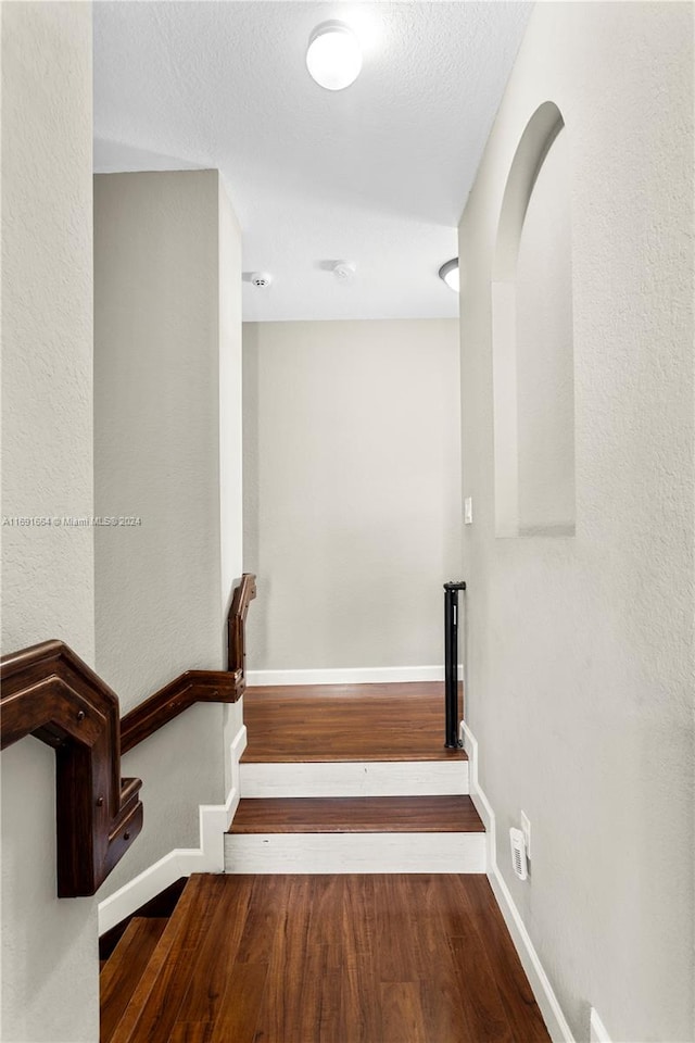 stairway with wood-type flooring