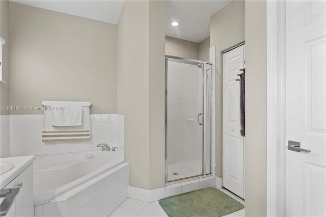 bathroom featuring plus walk in shower and tile patterned flooring