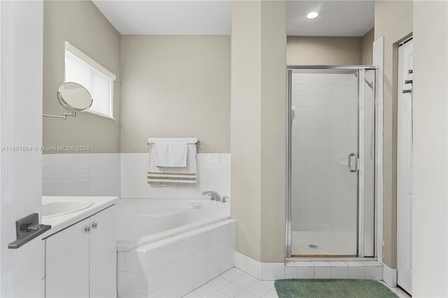 bathroom with vanity, tile patterned flooring, and separate shower and tub