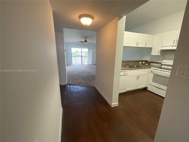 kitchen with white cabinets, dark hardwood / wood-style flooring, white appliances, and sink