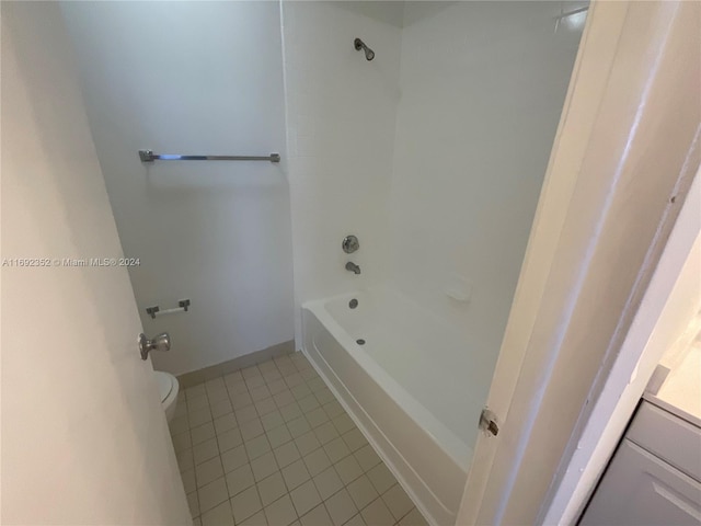 bathroom featuring  shower combination, toilet, and tile patterned floors