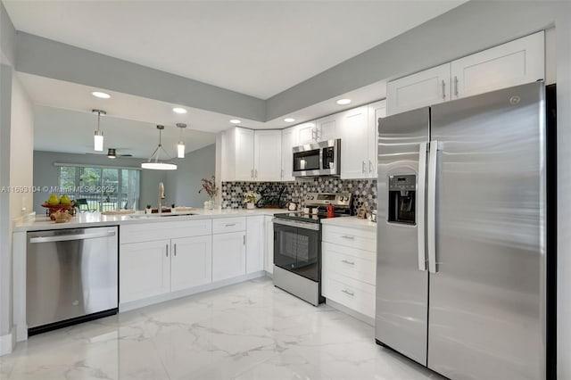 kitchen featuring appliances with stainless steel finishes, marble finish floor, a sink, and recessed lighting