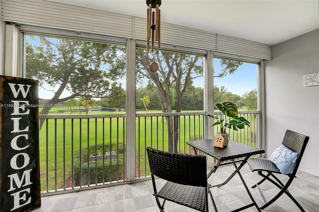 sunroom / solarium with a water view and a wealth of natural light
