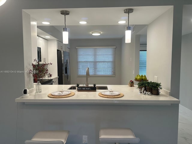 bathroom with a sink, recessed lighting, and marble finish floor