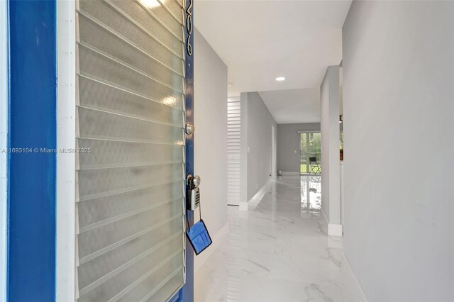 hallway featuring recessed lighting, marble finish floor, and baseboards