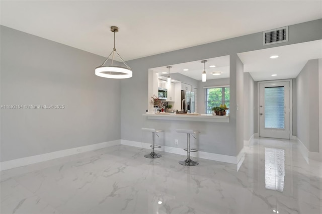 unfurnished dining area with visible vents, baseboards, and marble finish floor
