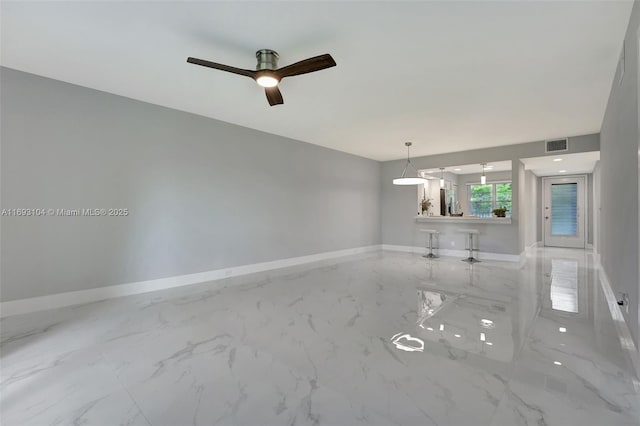 unfurnished room featuring visible vents, baseboards, ceiling fan, and marble finish floor