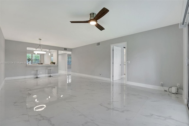 unfurnished living room featuring ceiling fan