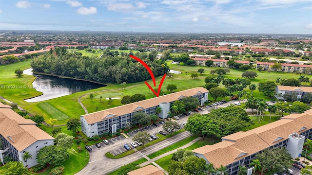 bird's eye view featuring a water view and view of golf course