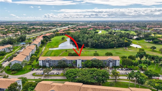 aerial view featuring a water view and golf course view