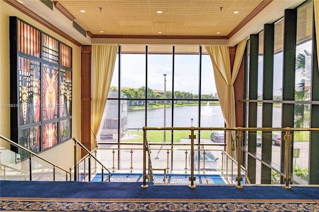 interior details featuring crown molding, recessed lighting, and a water view
