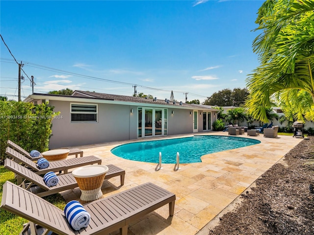 view of swimming pool with a patio area, outdoor lounge area, and french doors