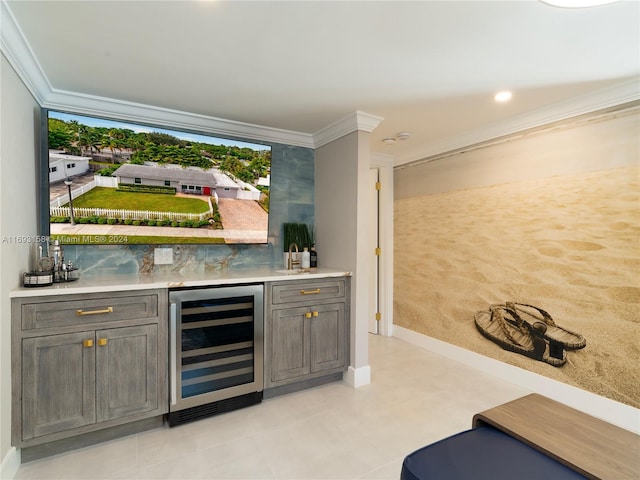 bar featuring beverage cooler and ornamental molding