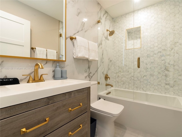 full bathroom featuring vanity, tiled shower / bath, and toilet