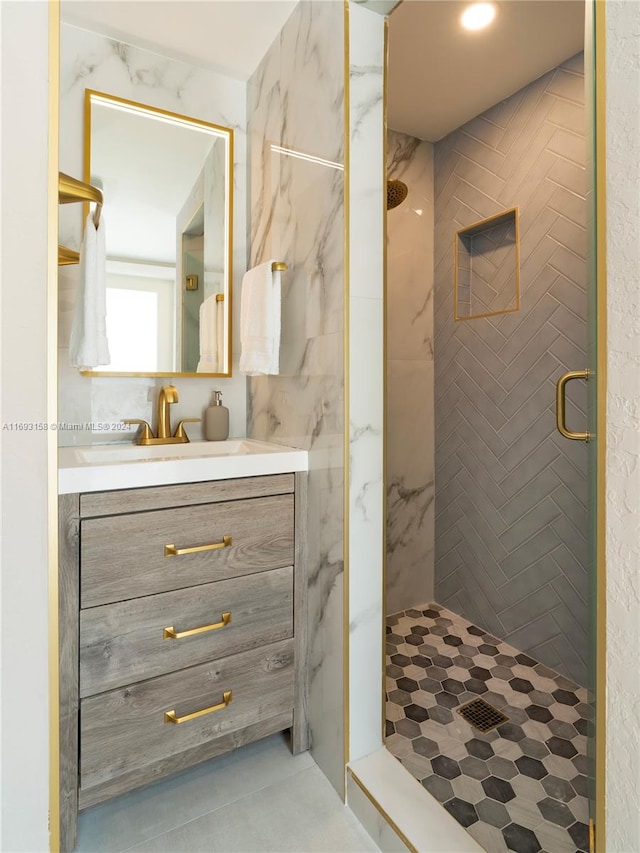 bathroom with vanity and a shower with door