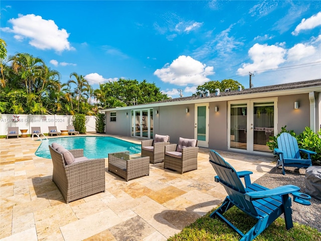 view of swimming pool featuring a patio and french doors