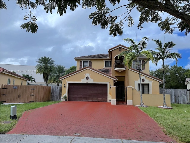 mediterranean / spanish-style house with a garage and a front yard