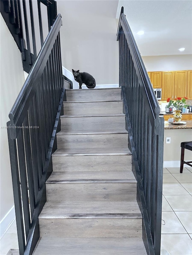 stairs featuring tile patterned flooring