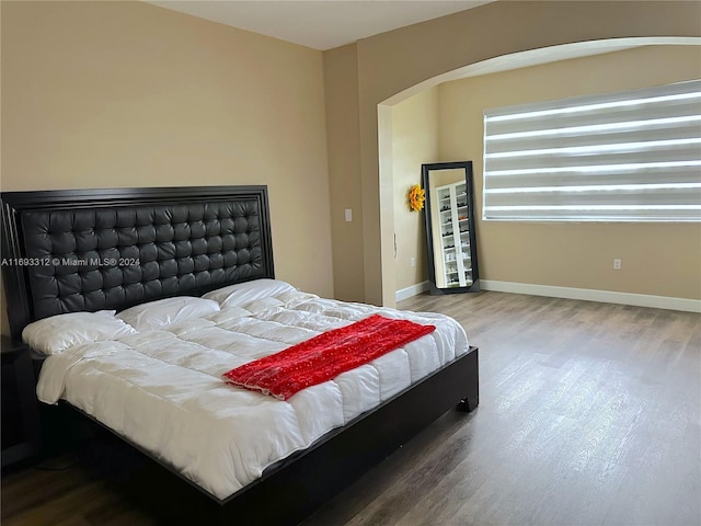 bedroom with hardwood / wood-style flooring