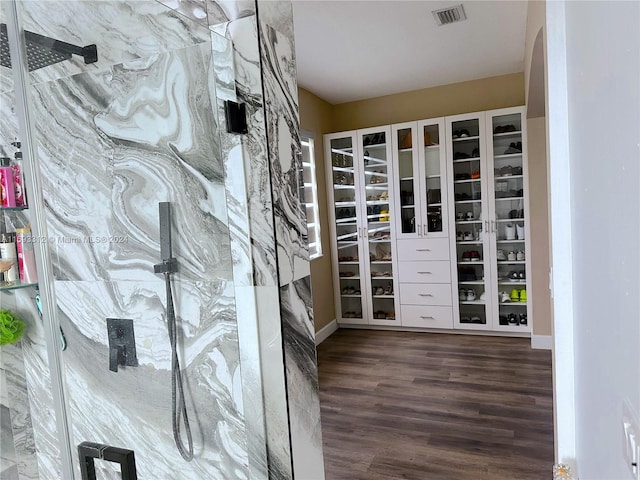 spacious closet featuring dark hardwood / wood-style floors