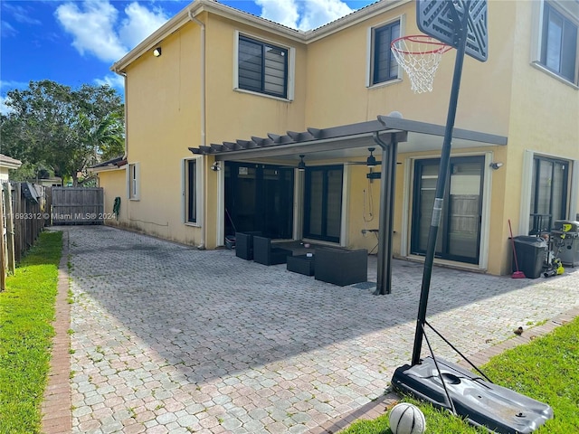 back of house with outdoor lounge area and a patio