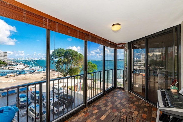 unfurnished sunroom featuring a water view