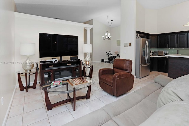 tiled living room featuring an inviting chandelier, high vaulted ceiling, and ornamental molding