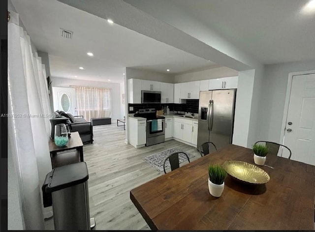 dining room featuring light hardwood / wood-style floors and sink