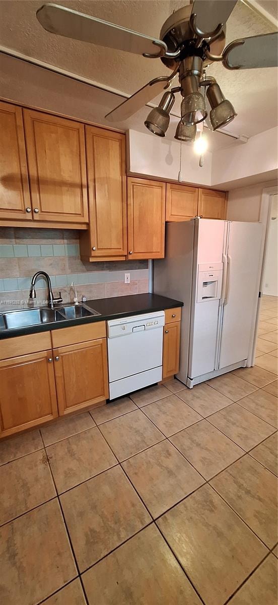 kitchen featuring backsplash, white appliances, ceiling fan, sink, and light tile patterned floors