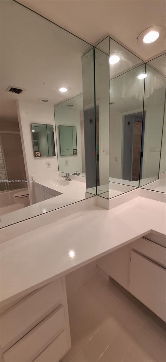 bathroom featuring tile patterned flooring and vanity