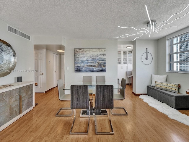 1833 S Ocean Dr Unit 1702, Hallandale Beach, FL 33009 - dining space featuring wood finished floors, a textured ceiling, and baseboards