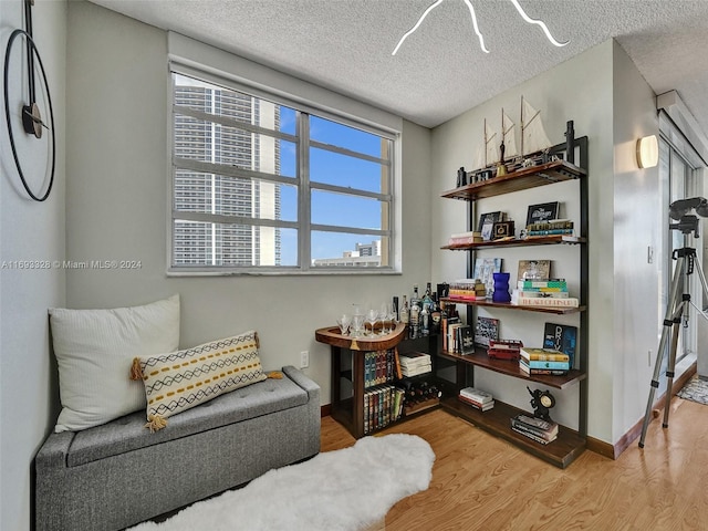 1833 S Ocean Dr Unit 1702, Hallandale Beach, FL 33009 - living area with wood finished floors, a textured ceiling, and baseboards