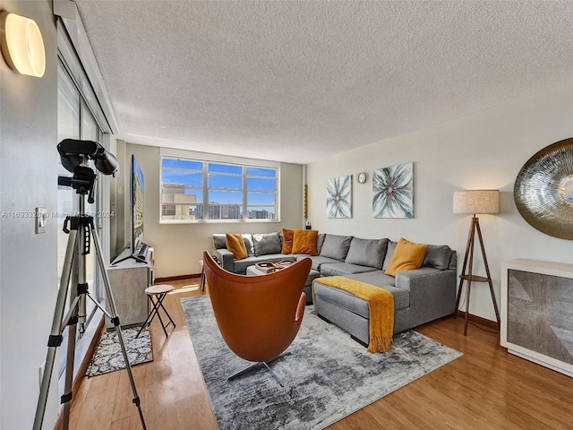 1833 S Ocean Dr Unit 1702, Hallandale Beach, FL 33009 - living room featuring a textured ceiling, wood finished floors, and baseboards