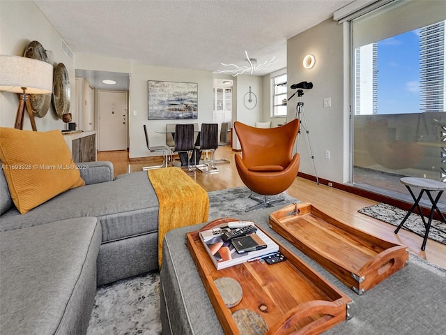 1833 S Ocean Dr Unit 1702, Hallandale Beach, FL 33009 - living area featuring a textured ceiling, wood finished floors, and baseboards