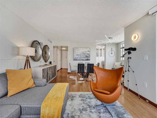 living room featuring hardwood / wood-style floors and a textured ceiling